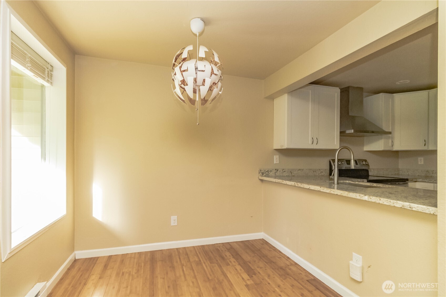 17425 119th Lane Southeast, Unit D12 Renton, WA 98058 - Photo 4 of 25 a view of a kitchen with wooden floor and a window