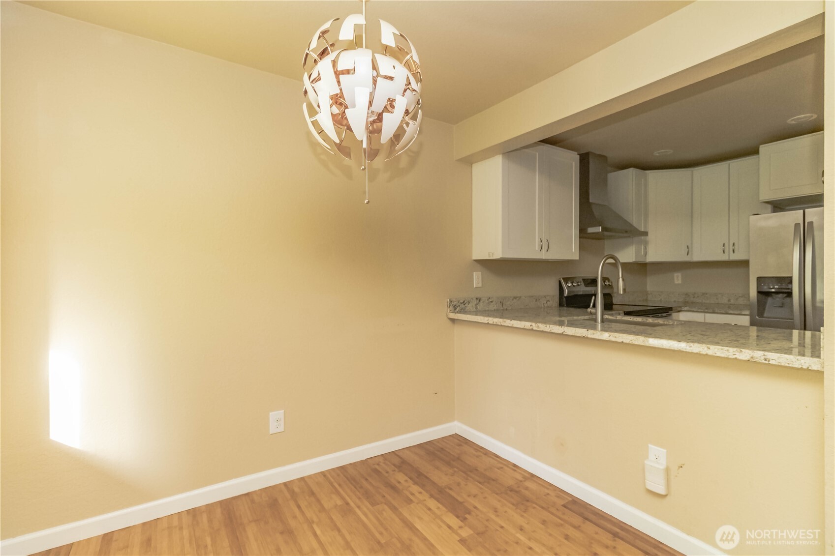 17425 119th Lane Southeast, Unit D12 Renton, WA 98058 - Photo 5 of 25 a view of a kitchen with wooden floor and a window