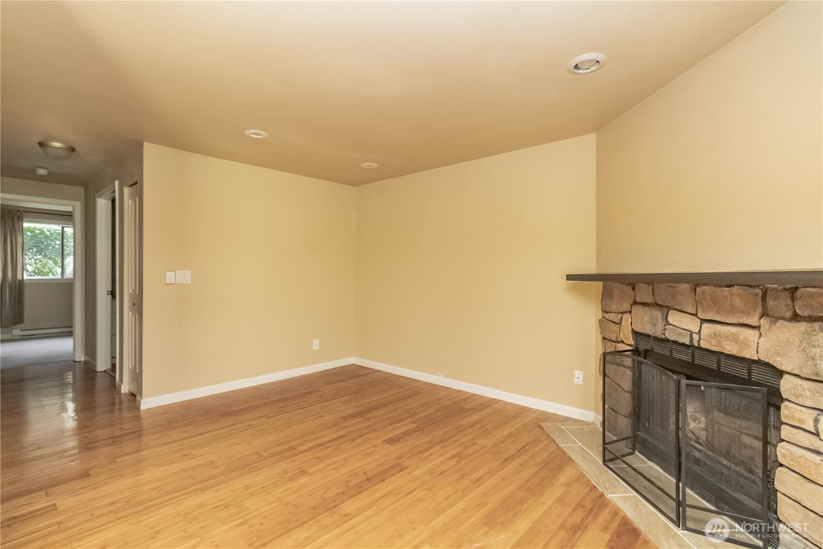 17425 119th Lane Southeast, Unit D12 Renton, WA 98058 - Photo 10 of 25 a view of a room with wooden floor and chair