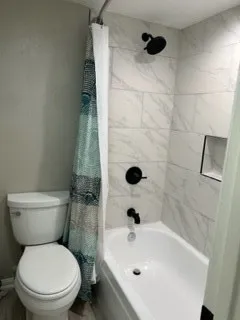 a view of swimming pool with lawn chairs and large trees