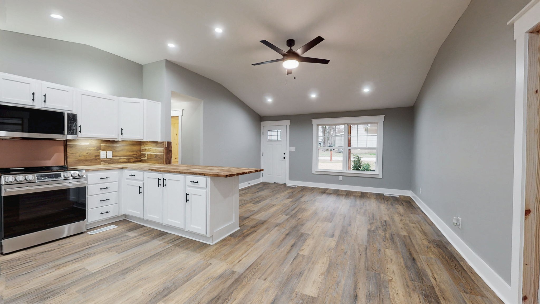 108 Decatur Street Shelbyville, TN 37160 - Photo 11 of 33 a open kitchen with stainless steel appliances granite countertop a stove top oven a sink and a dishwasher with wooden floor