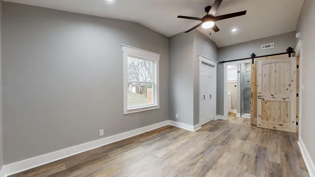 a view of empty room with wooden floor