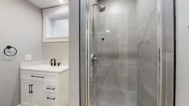 a bathroom with a sink mirror and shower