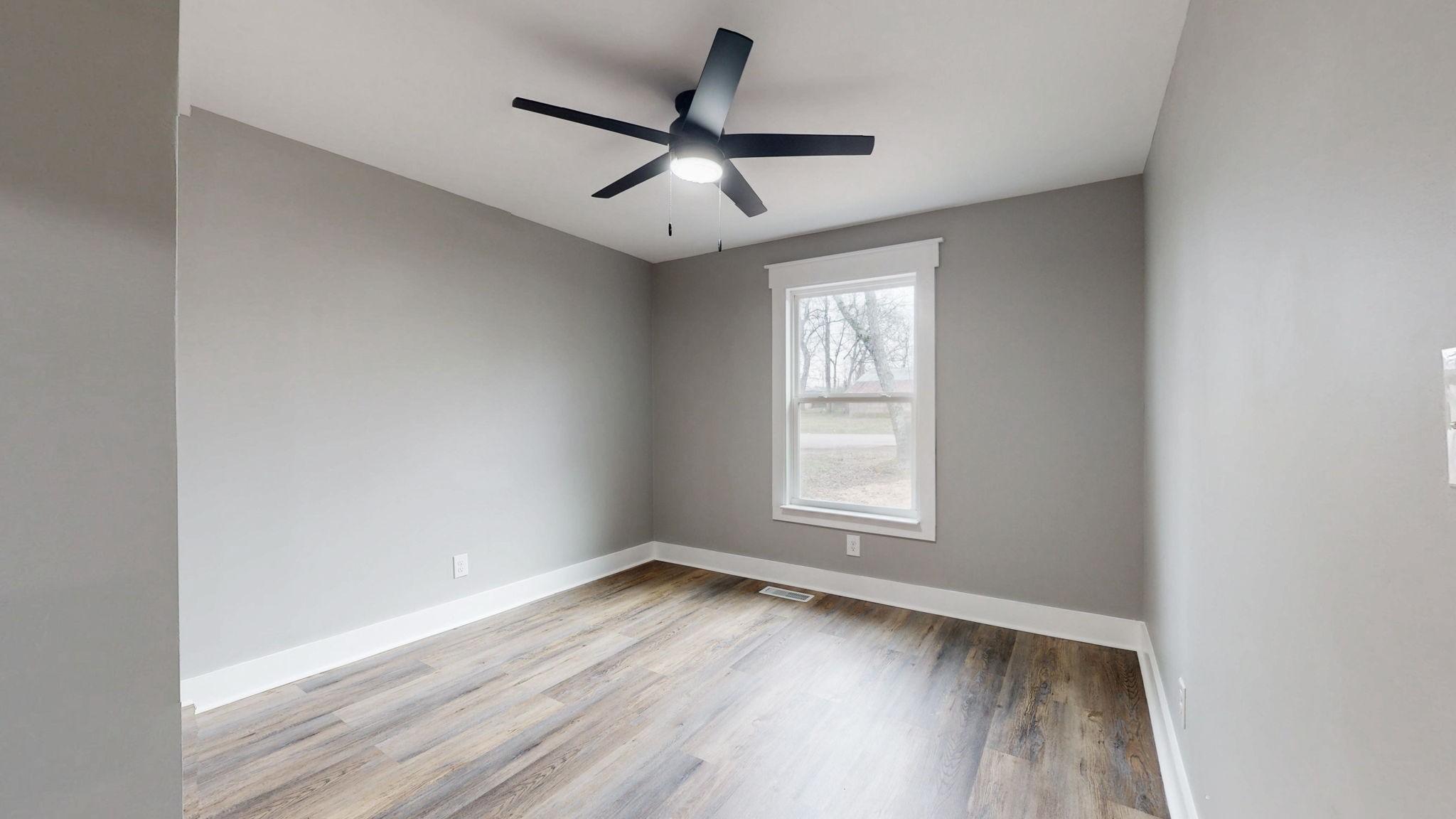 108 Decatur Street Shelbyville, TN 37160 - Photo 24 of 33 an empty room with wooden floor ceiling fan and window