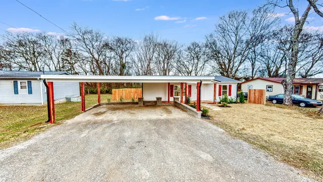 a view of house with outdoor space and sitting area