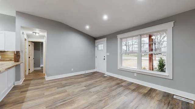 wooden floor in an empty room with a window