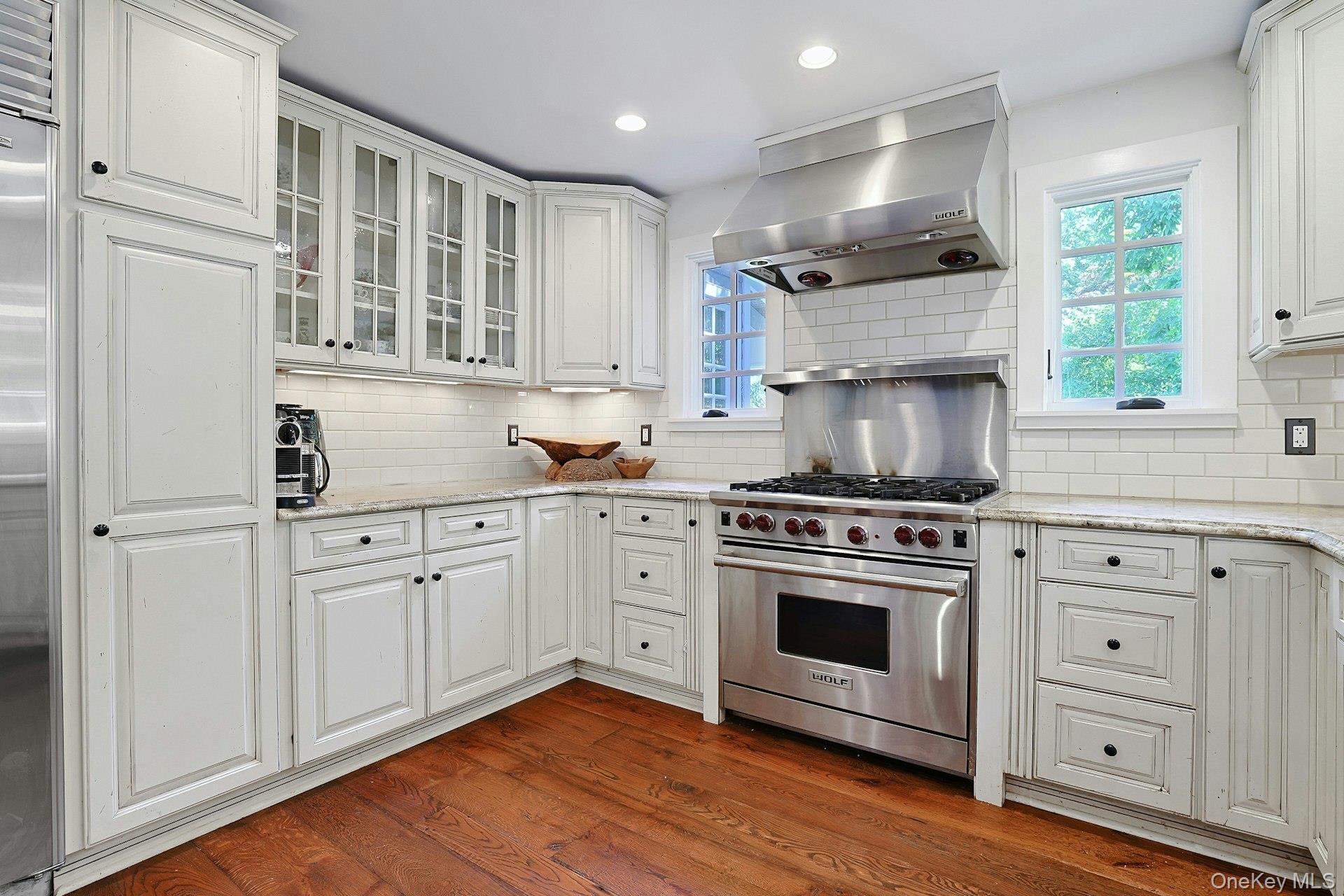 65 Douglas Road Chappaqua, NY 10514 - Photo 21 of 41 A chef’s kitchen with a Wolf stove, generous workspace, and beautiful backyard views, designed to make cooking, entertaining, and everyday moments feel effortless.