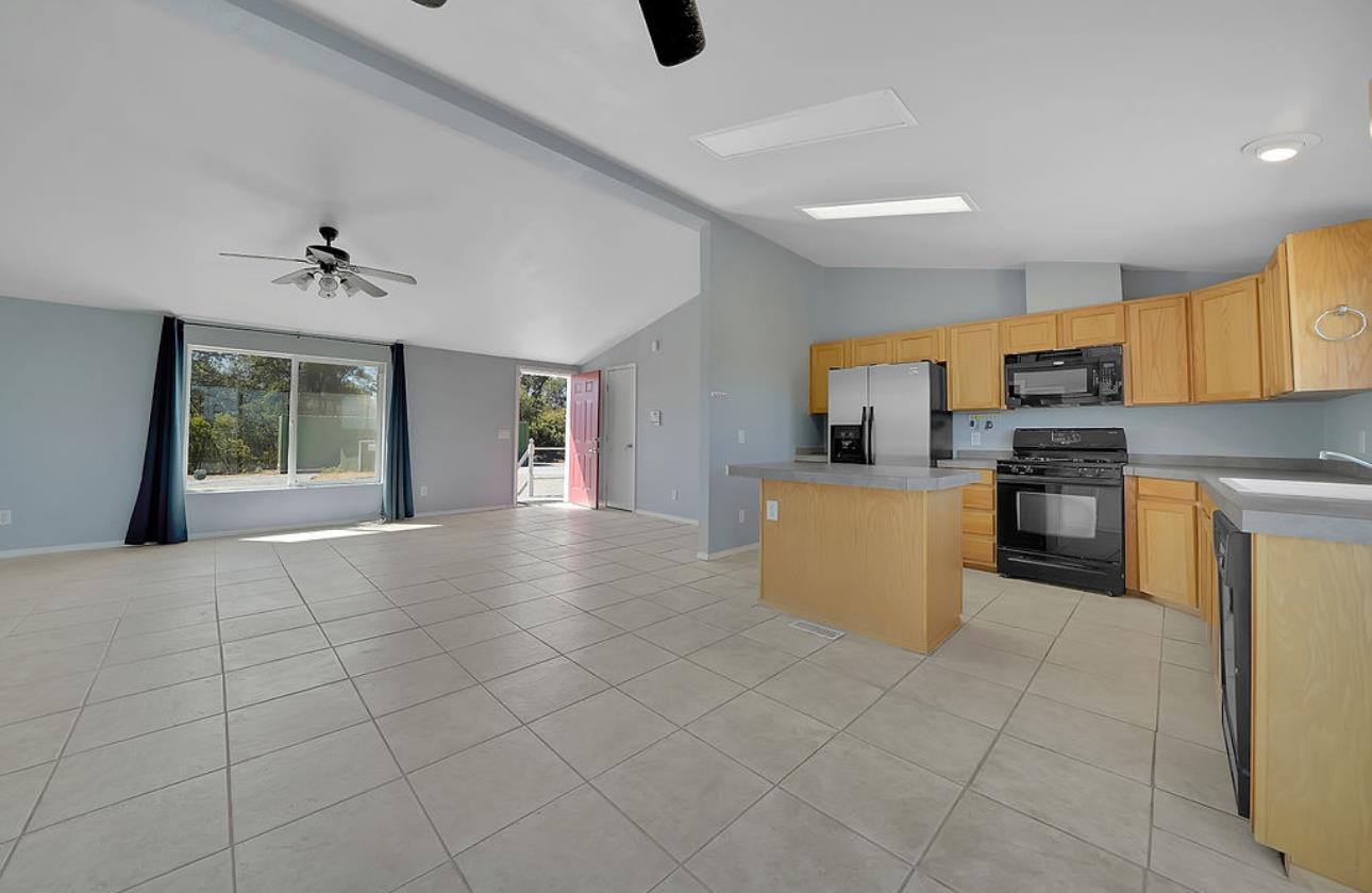 3155 Hawver Road San Andreas, CA 95249 - Photo 11 of 62 a kitchen with stainless steel appliances granite countertop a stove top oven a sink a counter top space and cabinets