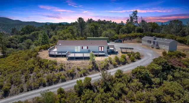 a view of a house with a mountain in the background