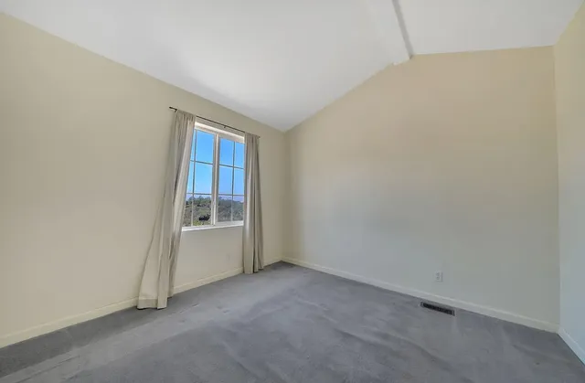 an aerial view of a house with garden space and a sitting area