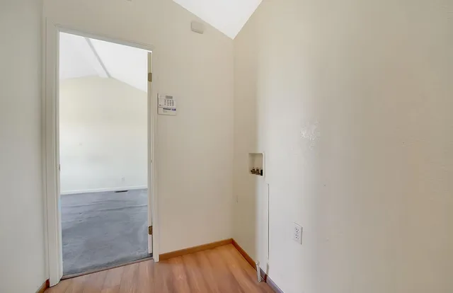 an aerial view of a house with a yard and large tree