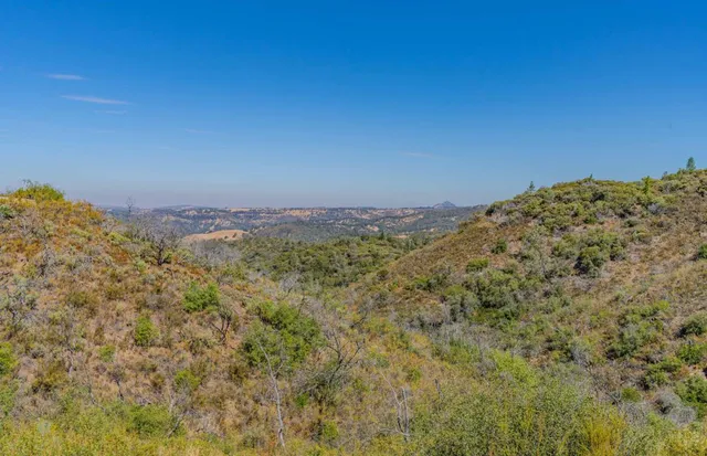 an aerial view of a house with mountain view