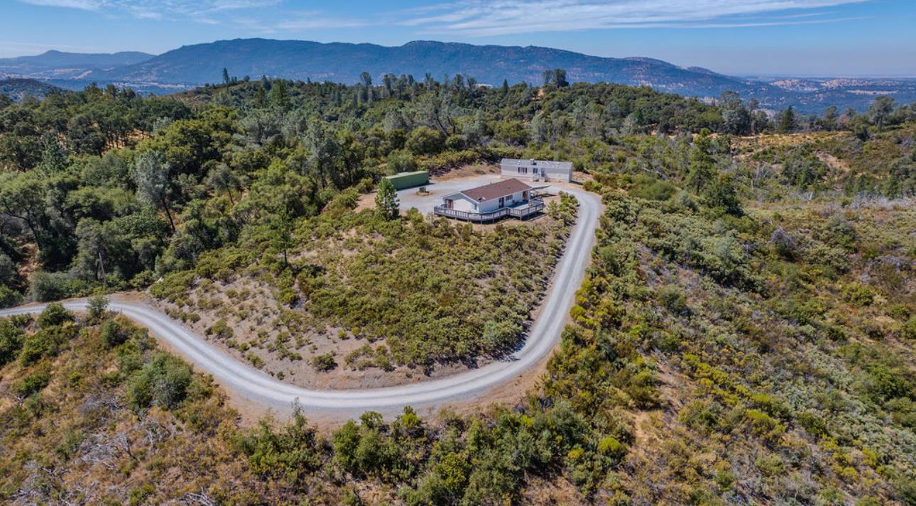 3155 Hawver Road San Andreas, CA 95249 - Photo 60 of 62 a view of a lush green forest with mountains and a houses