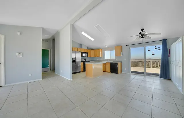 a kitchen with stainless steel appliances granite countertop a stove top oven a sink a counter top space and cabinets