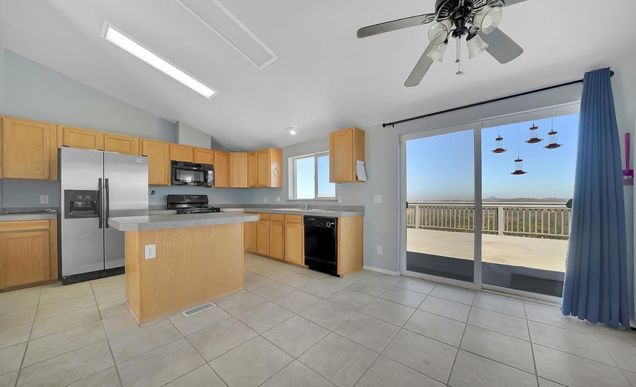 3155 Hawver Road San Andreas, CA 95249 - Photo 10 of 62 a kitchen with stainless steel appliances granite countertop a refrigerator and a sink