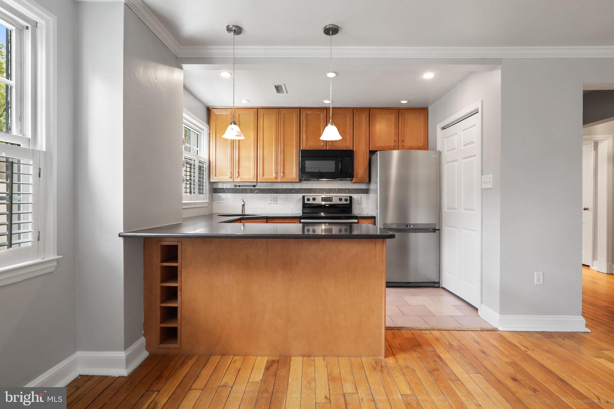 2912 13th Road South, Unit 204 Arlington, VA 22204 - Photo 12 of 32 a kitchen with stainless steel appliances a refrigerator and a stove top oven