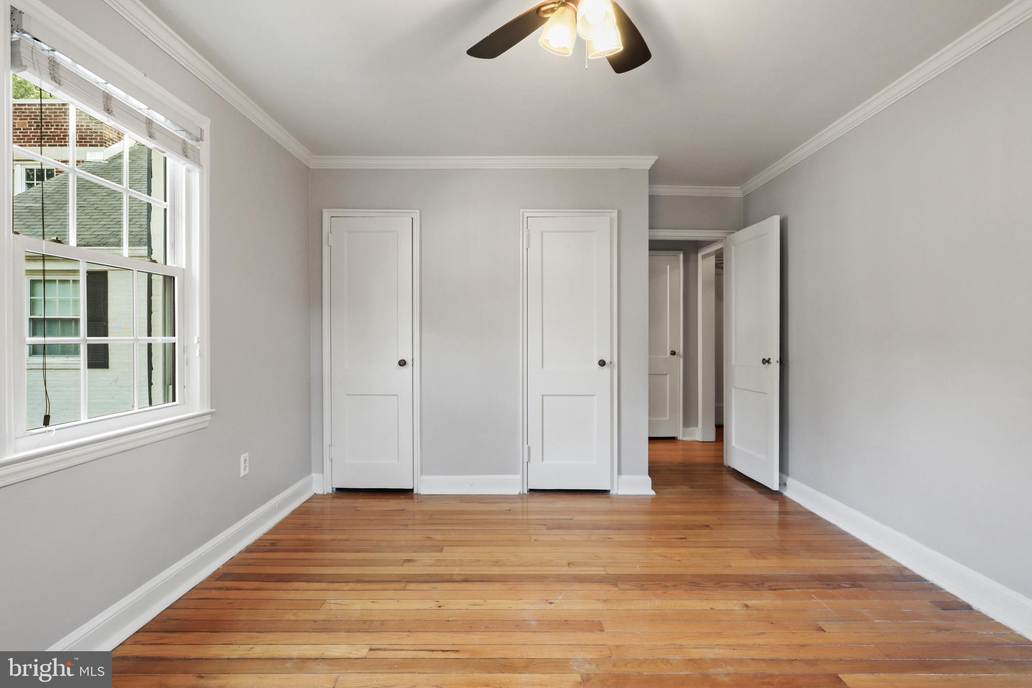 2912 13th Road South, Unit 204 Arlington, VA 22204 - Photo 16 of 32 a view of empty room with wooden floor and window