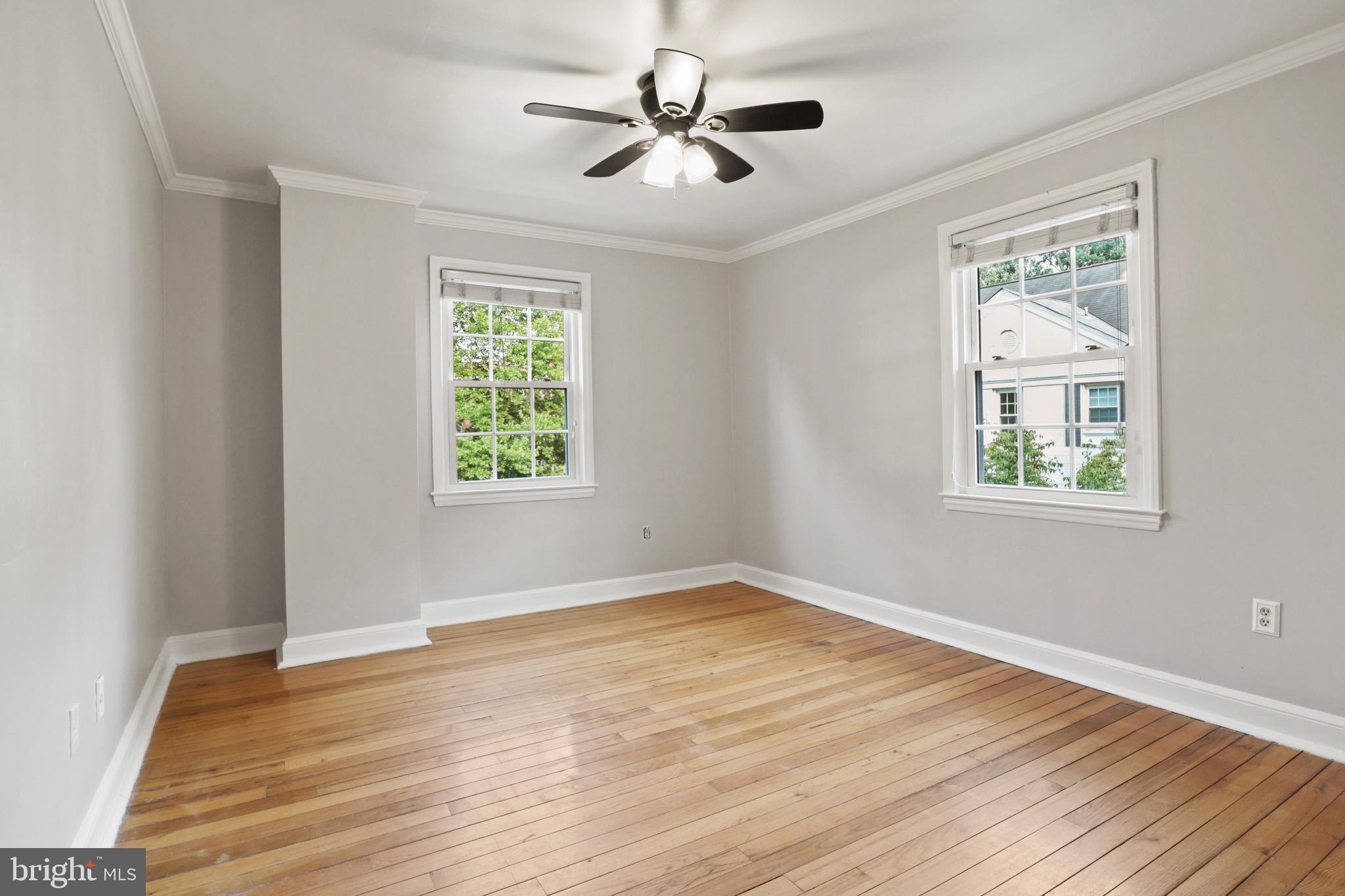 2912 13th Road South, Unit 204 Arlington, VA 22204 - Photo 18 of 32 a view of an empty room with window and wooden floor