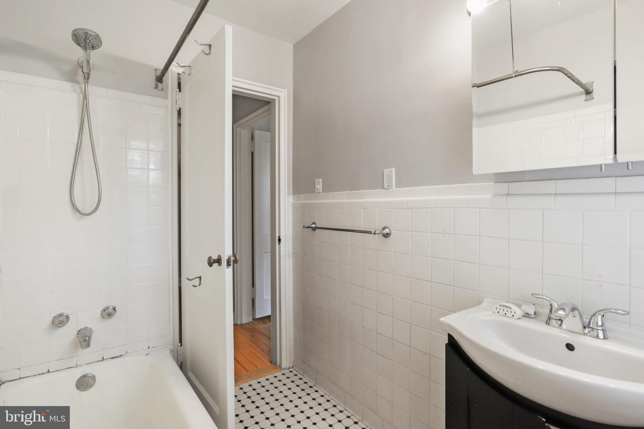 2912 13th Road South, Unit 204 Arlington, VA 22204 - Photo 19 of 32 a bathroom with a sink a toilet and shower