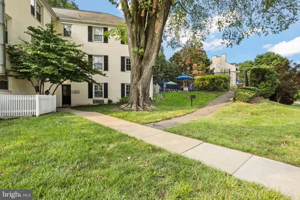 a view of a house with a yard and tree s