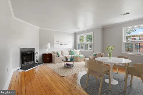 a living room with furniture a fireplace and a table
