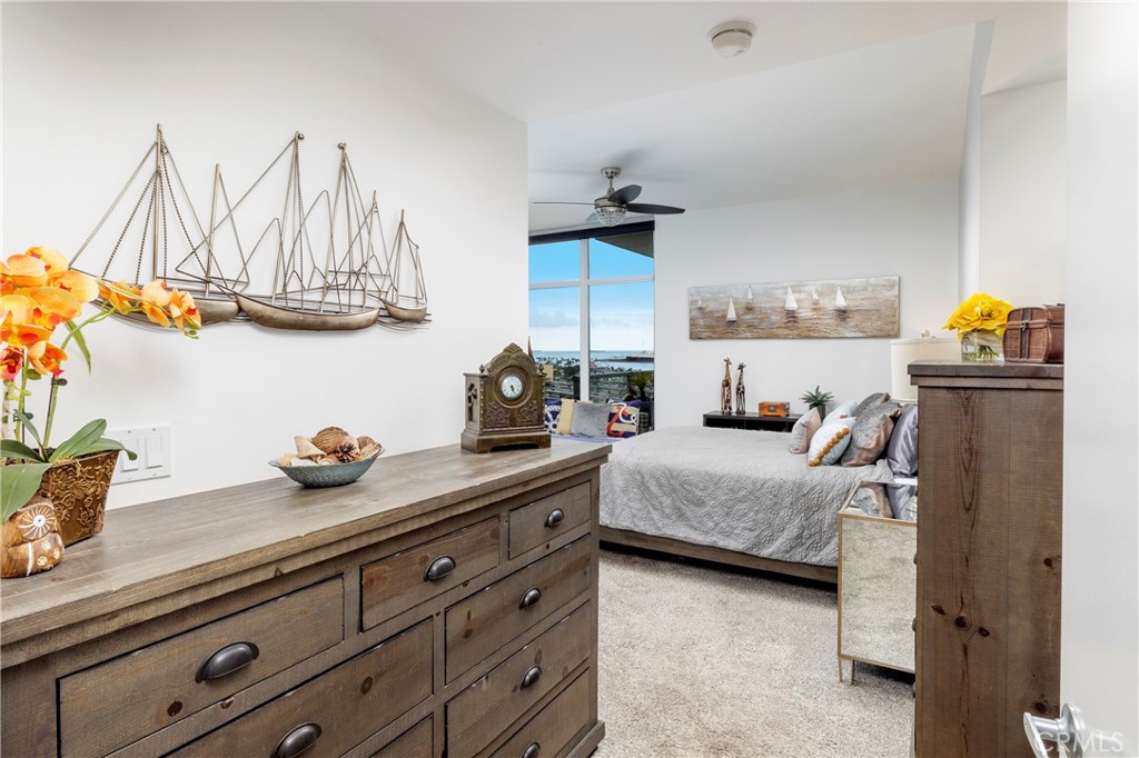 400 West Ocean Boulevard, Unit 902 Long Beach, CA 90802 - Photo 13 of 32 a bedroom with a bed and cabinets