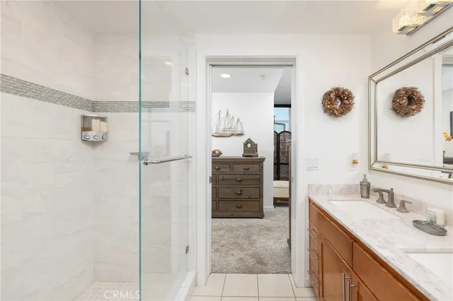 a bathroom with a granite countertop shower sink and mirror