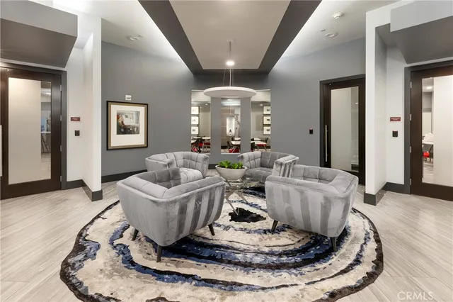 a living room with furniture and a chandelier