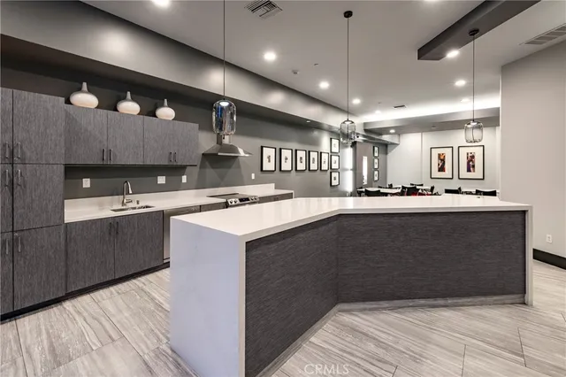 a kitchen with kitchen island a sink stainless steel appliances and cabinets