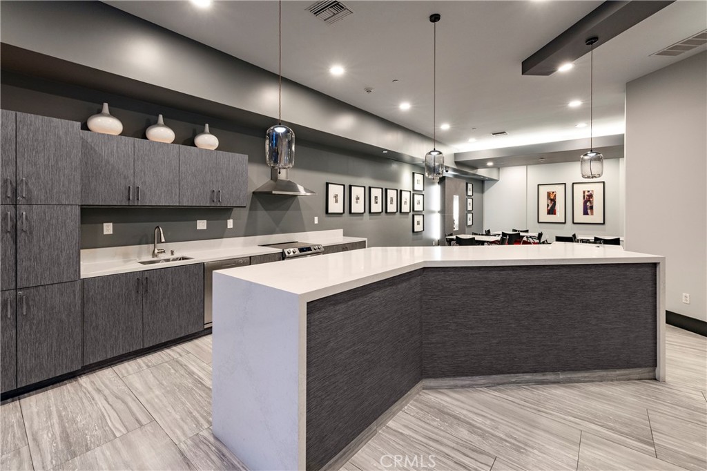 400 West Ocean Boulevard, Unit 902 Long Beach, CA 90802 - Photo 28 of 32 a kitchen with kitchen island a sink stainless steel appliances and cabinets