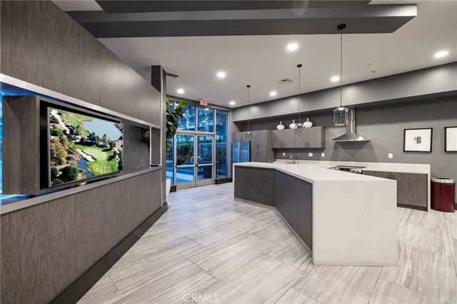 a large kitchen with stainless steel appliances a large counter top