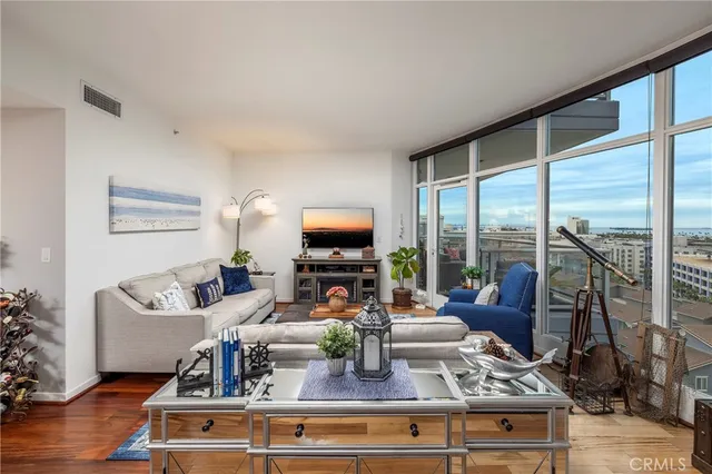 a view of living room with furniture large window and flat screen tv