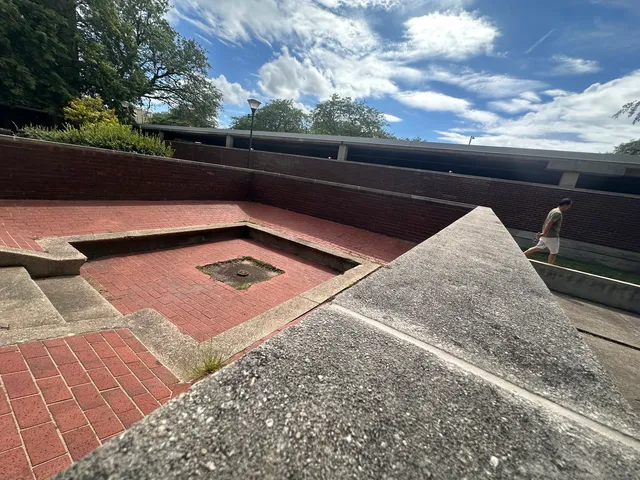 a view of a tennis court with sitting area