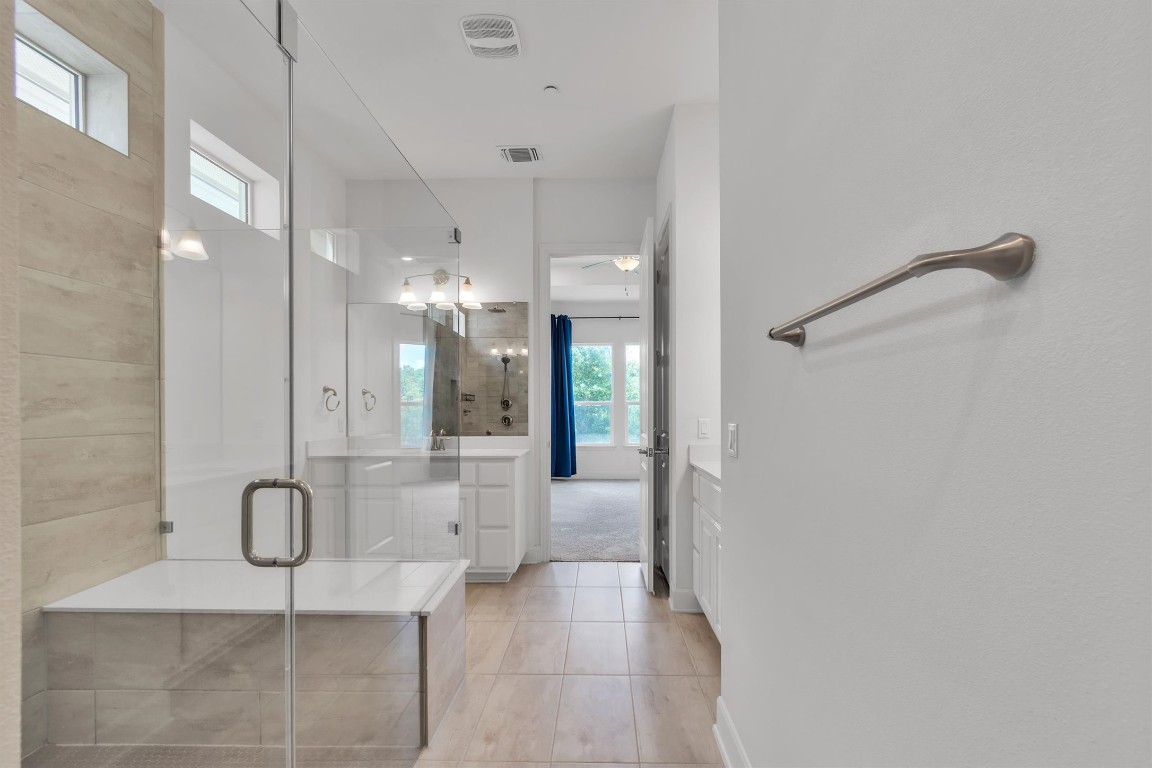 12110 Moriah Bend Austin, TX 78732 - Photo 17 of 40 a bathroom with a glass shower door