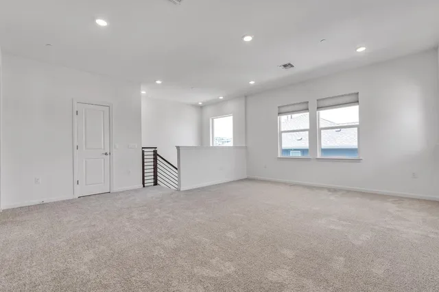 an empty room with windows and closet