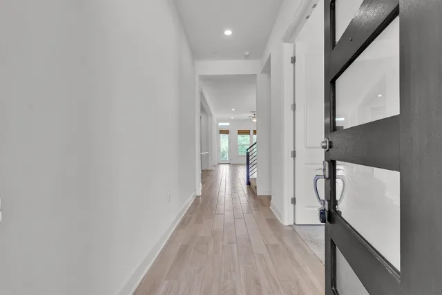 a view of hallway with wooden floor
