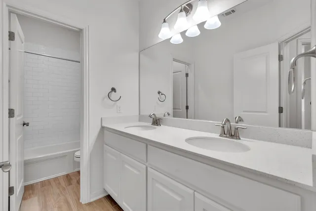 a bathroom with a sink a light fixture and a mirror