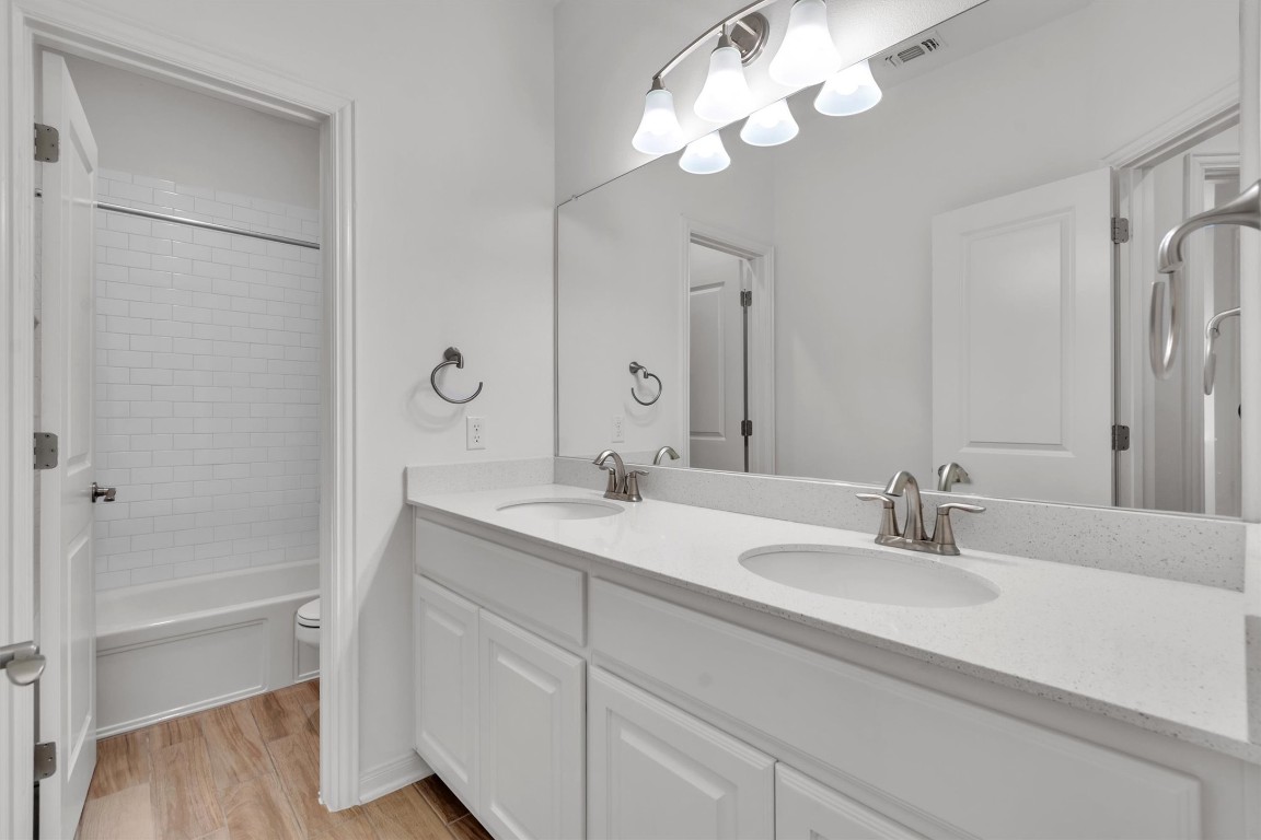 12110 Moriah Bend Austin, TX 78732 - Photo 23 of 40 a bathroom with a sink a light fixture and a mirror