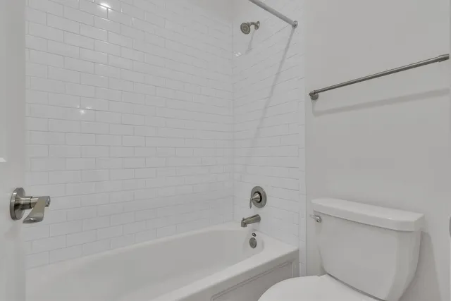 a bathroom with a bathtub and a toilet