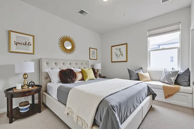 a bedroom with a bed and a painting on the wall