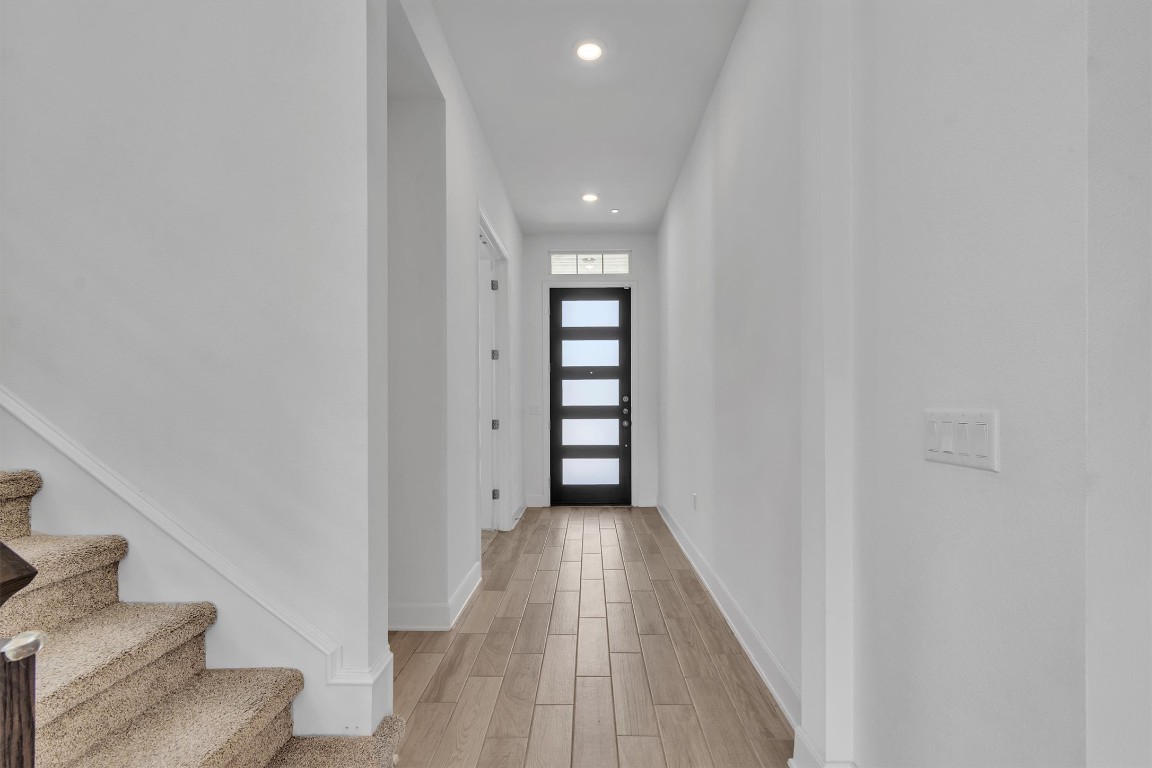 12110 Moriah Bend Austin, TX 78732 - Photo 3 of 40 a view of a hallway with wooden floor and staircase