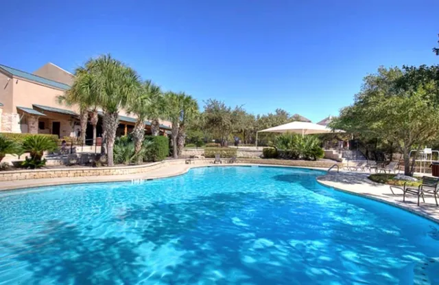 a swimming pool with outdoor seating and yard