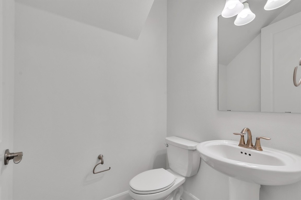 12110 Moriah Bend Austin, TX 78732 - Photo 4 of 40 a bathroom with a sink a toilet and mirror