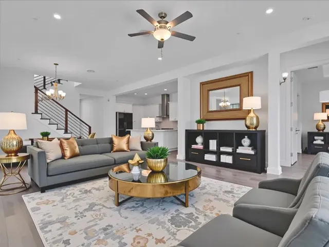 a living room with furniture and wooden floor