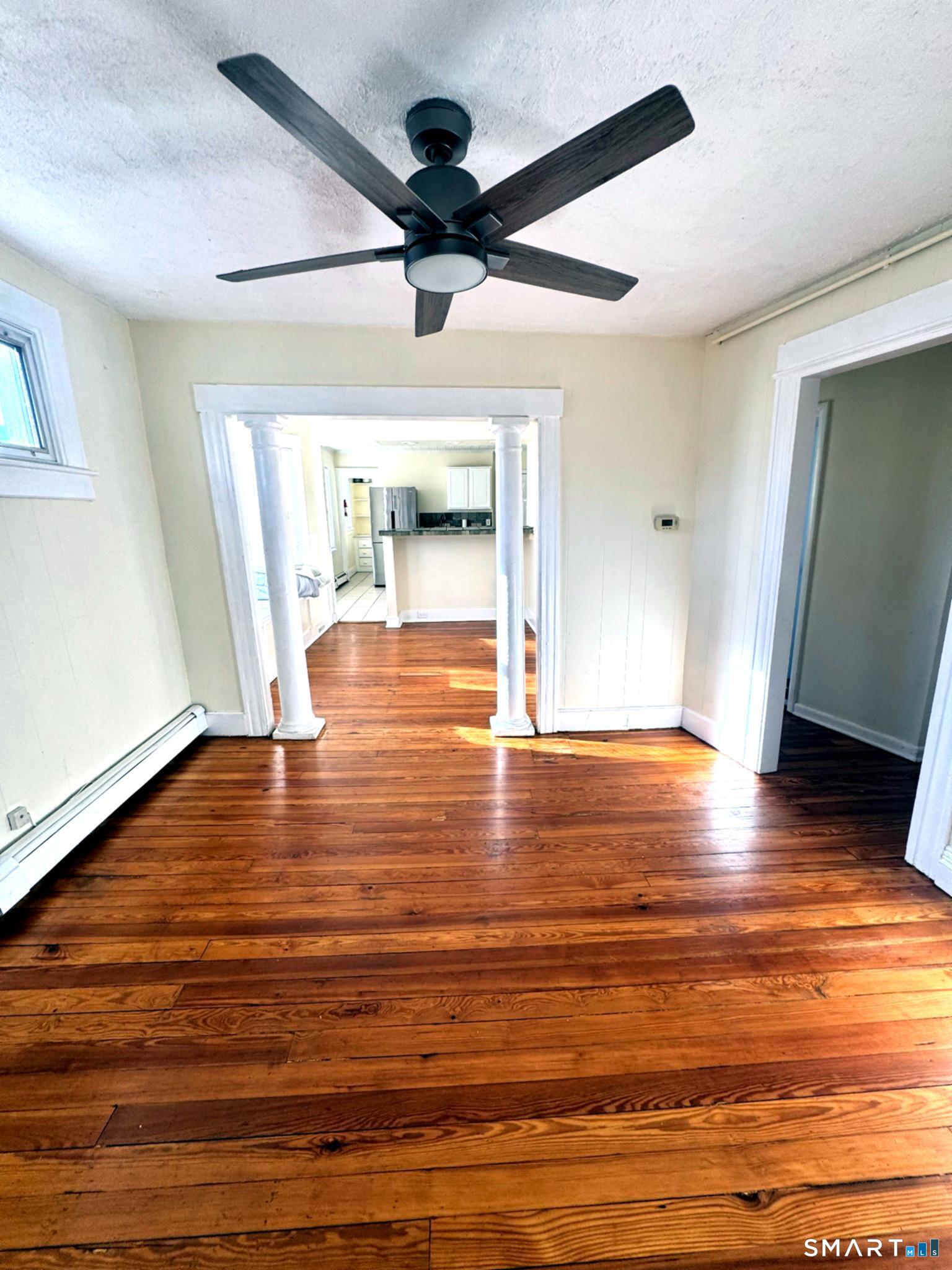 175 Wilson Street, Unit 179 Bridgeport, CT 06605 - Photo 2 of 9 a view of empty room with wooden floor