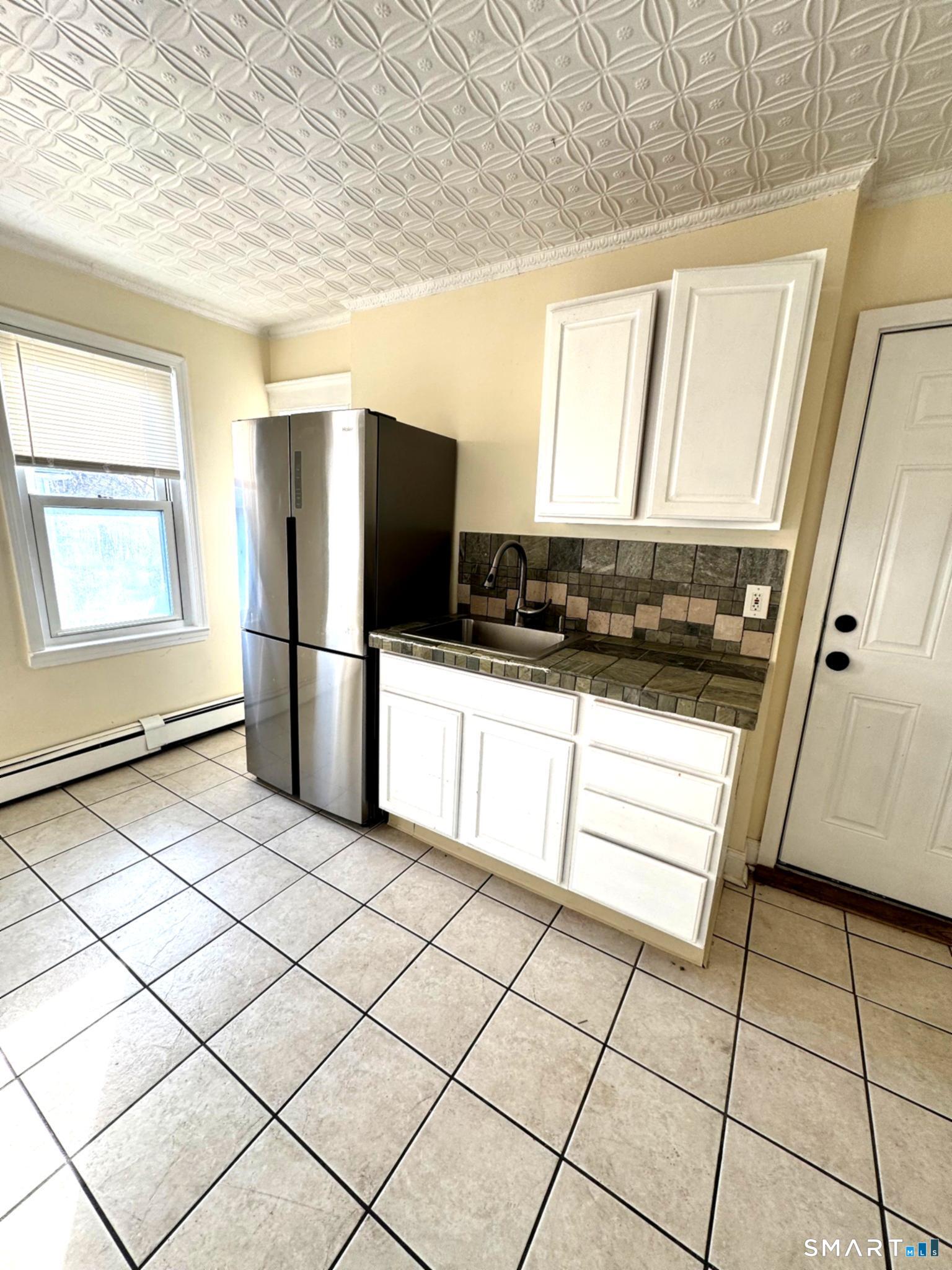 175 Wilson Street, Unit 179 Bridgeport, CT 06605 - Photo 3 of 9 a kitchen with stainless steel appliances a refrigerator sink and microwave