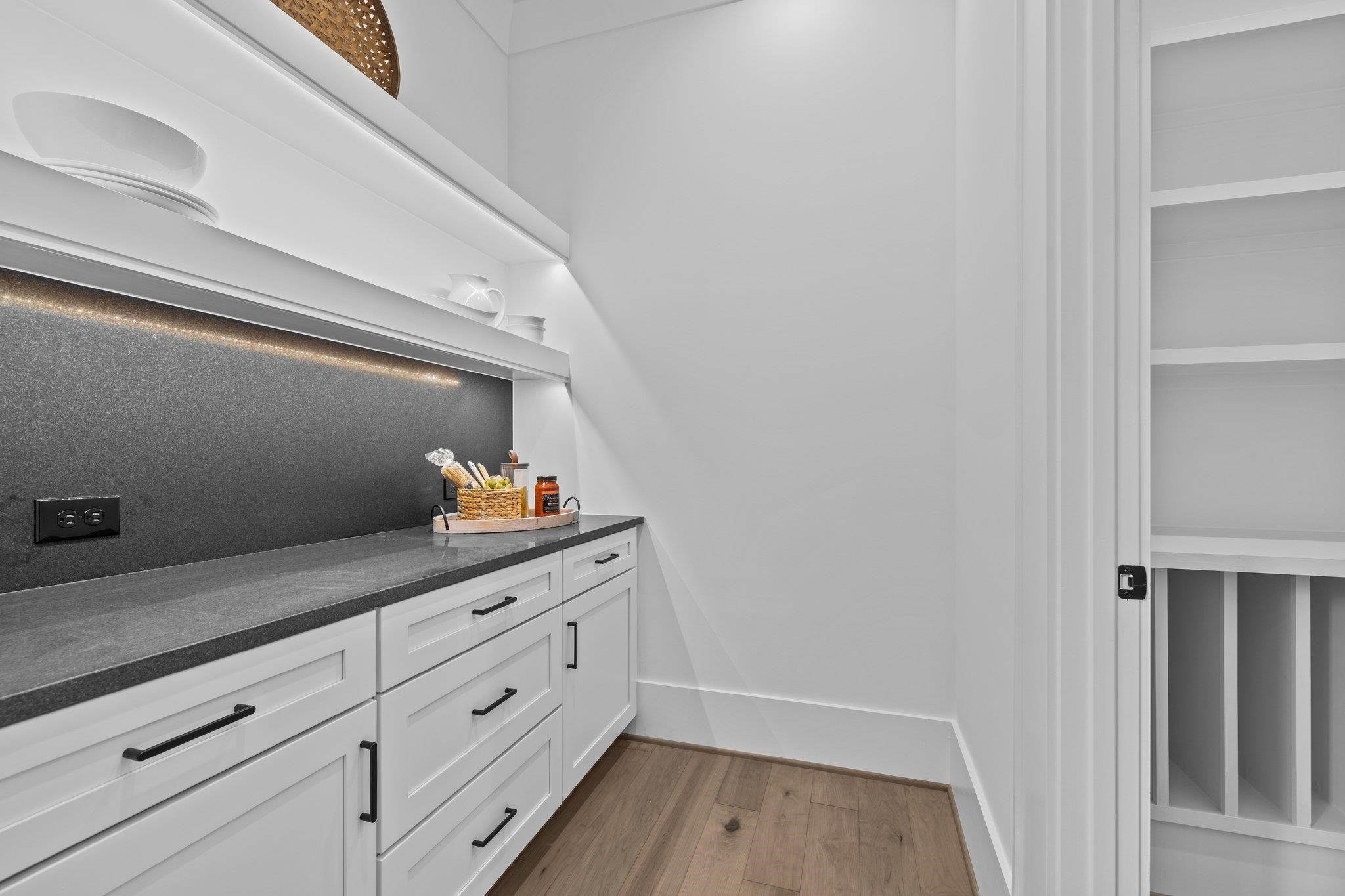 7605 Harps Mill Road Raleigh, NC 27615 - Photo 23 of 70 a kitchen with cabinets and wooden floor