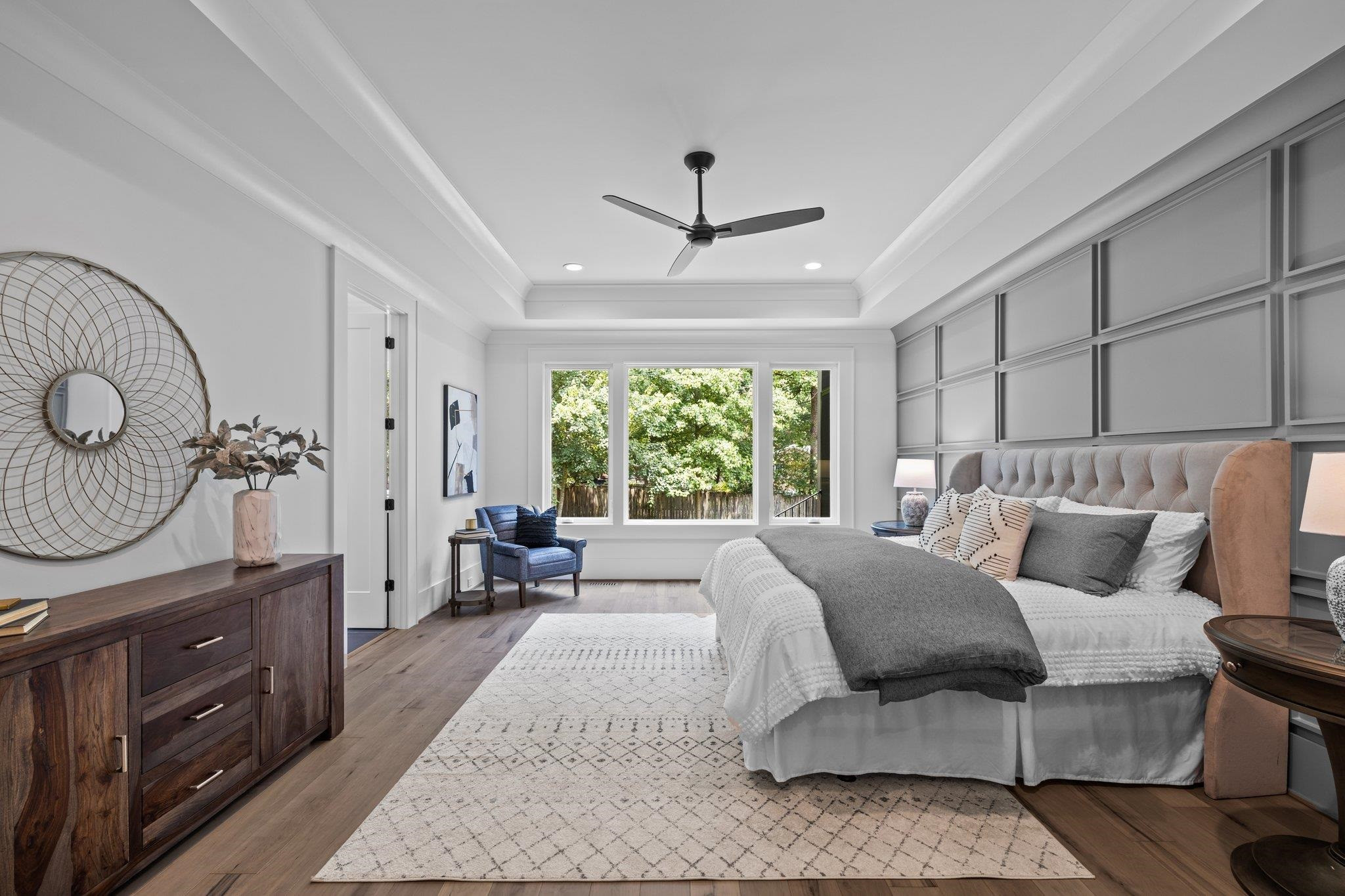 7605 Harps Mill Road Raleigh, NC 27615 - Photo 28 of 70 a bed room with a bed a dresser and a chandelier