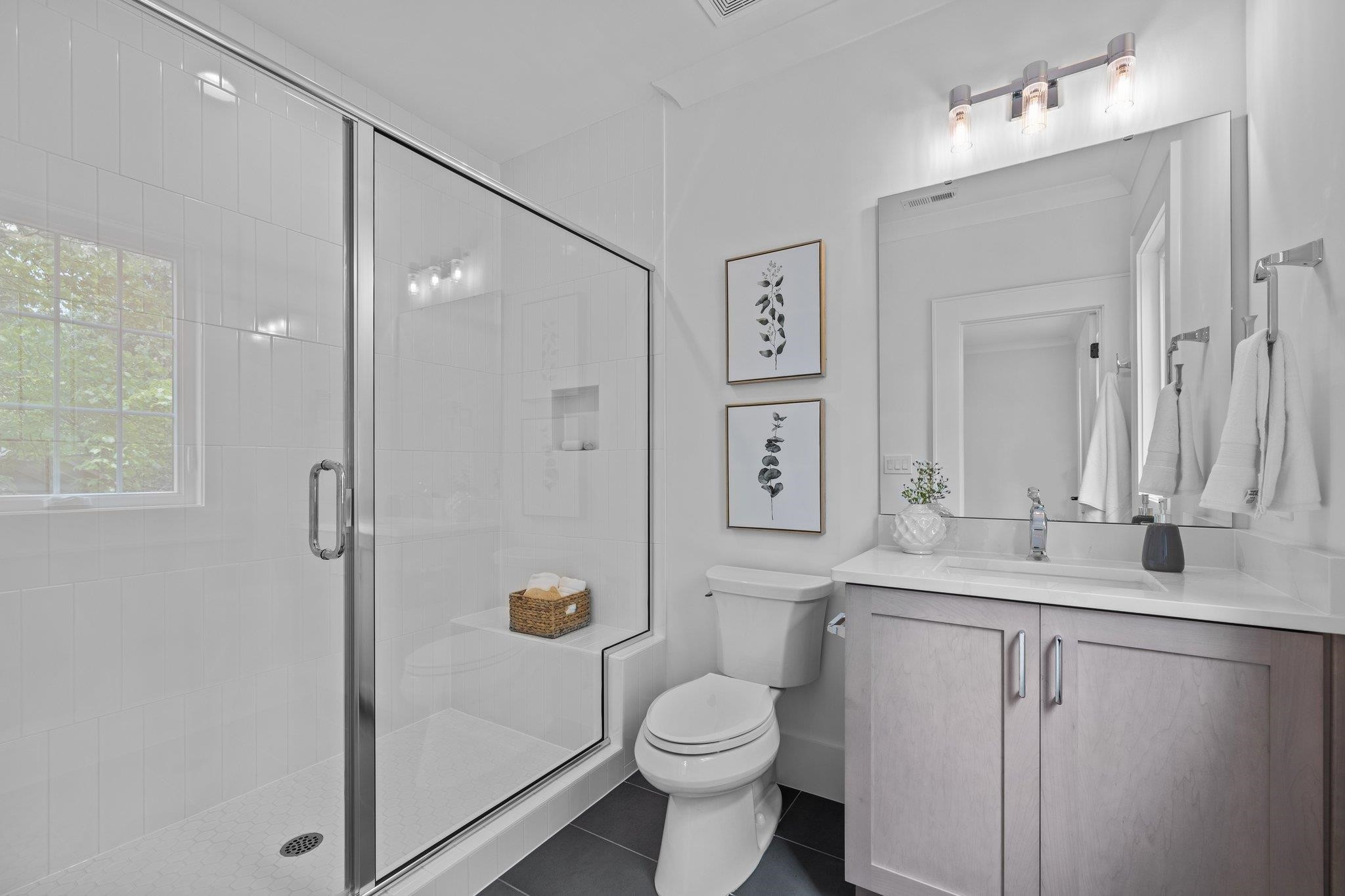 7605 Harps Mill Road Raleigh, NC 27615 - Photo 48 of 70 a bathroom with a sink a toilet and shower