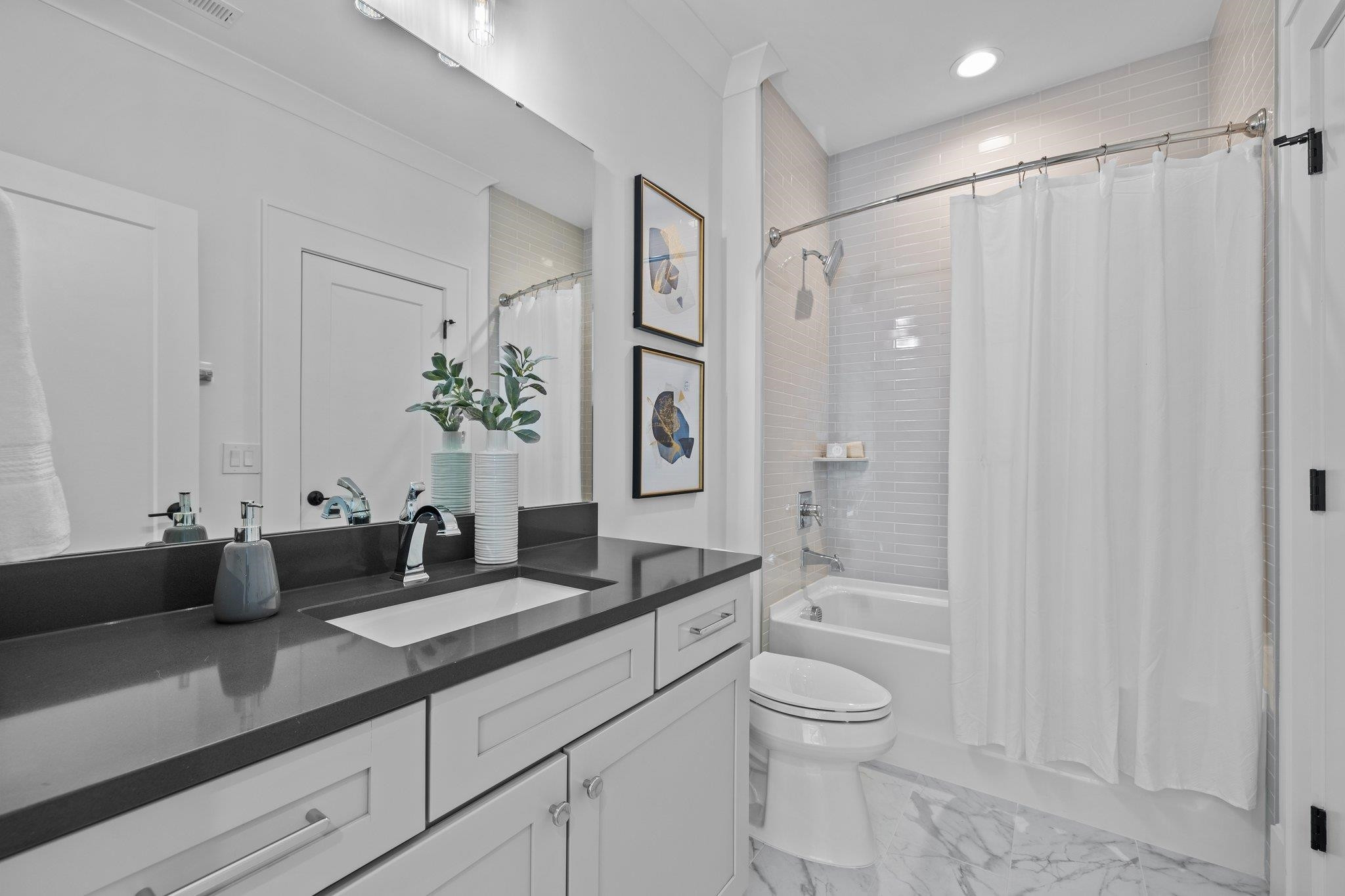 7605 Harps Mill Road Raleigh, NC 27615 - Photo 49 of 70 a spacious bathroom with a granite countertop sink a toilet and a large mirror